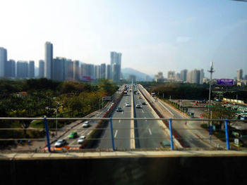 Tilt-shift image of cityscape against sky