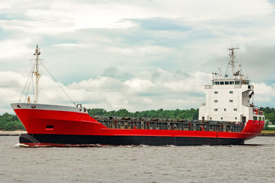 Ship sailing in sea against sky