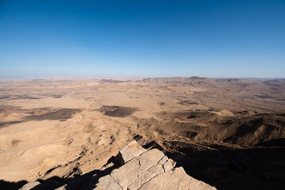 Scenic view of dramatic landscape against clear blue sky