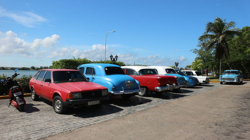 Cars on road against blue sky