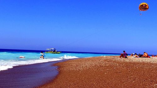 Scenic view of beach against blue sky