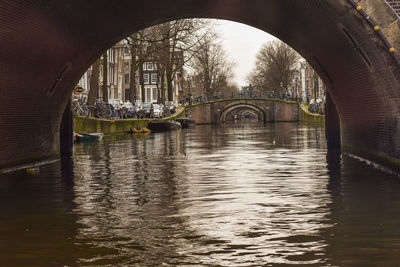Arch bridge over canal in amsterdam