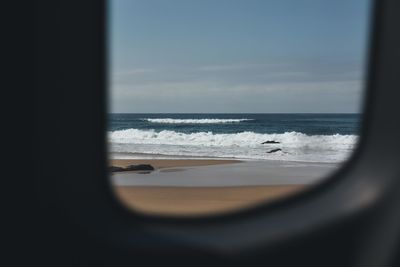 Scenic view of sea seen through window