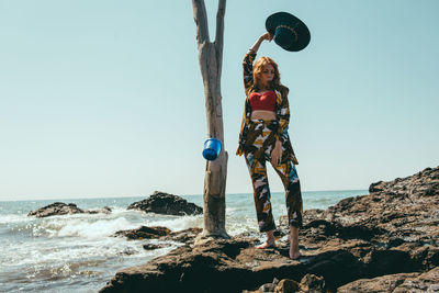 Fashionable woman standing on beach