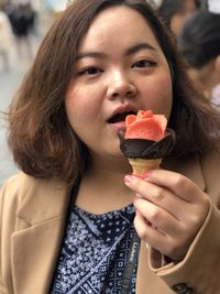 Close-up of young woman eating ice cream