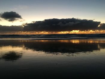 Reflection of clouds in water at sunset