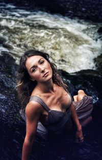 Portrait of a smiling young woman in water