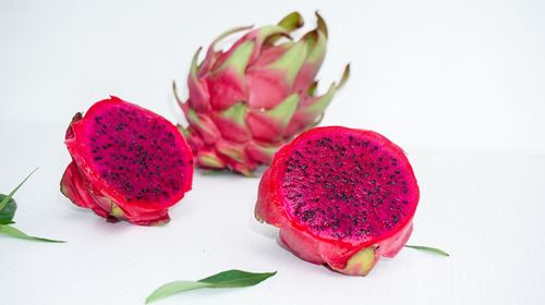 Close-up of strawberries on table against white background