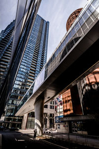 Low angle view of modern buildings in city against sky