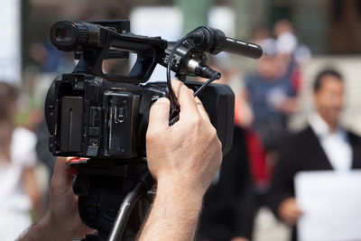 Close-up of man photographing camera