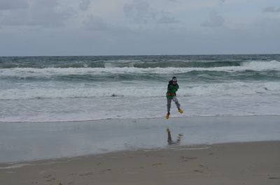 Full length of man on beach against sky