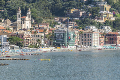 Scenic view of beach by buildings in city