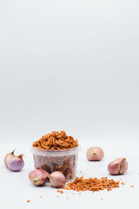 Close-up of food on table against white background