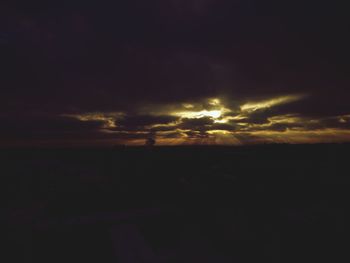 Silhouette landscape against sunset sky