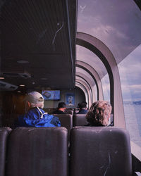 Rear view of people sitting in train