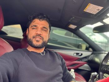 Portrait of young man in car