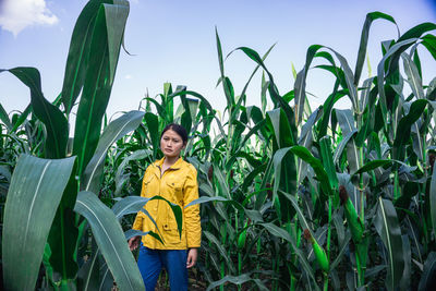 Portrait of smiling young woman standing on field