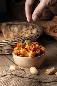 Close-up of hand holding mushrooms on table