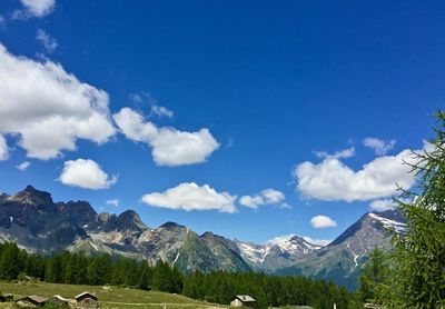 Scenic view of mountains against blue sky