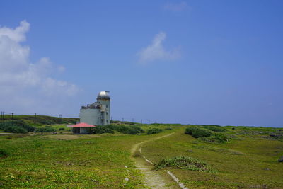 Scenic view of land against blue sky