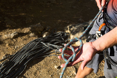 Close-up of man working with rope