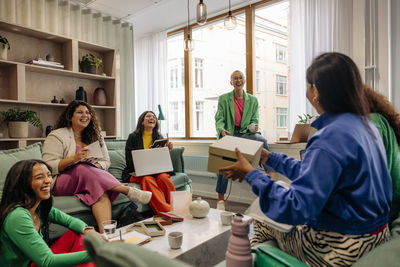 Happy female entrepreneurs having fun during business meeting at workplace