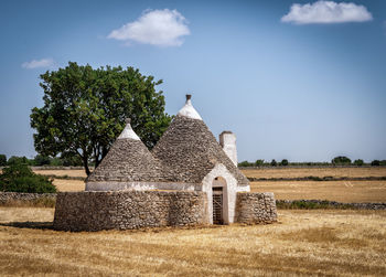 Old building on field against sky