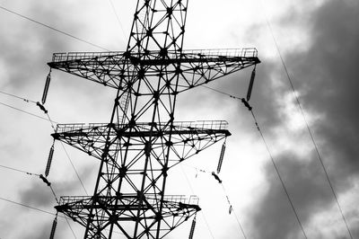 Low angle view of electricity pylon against sky