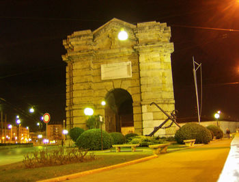 Illuminated building against sky at night