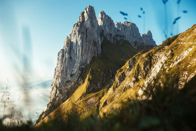 Low angle view of rock formation against sky