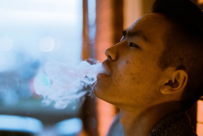 Close-up of man exhaling smoke