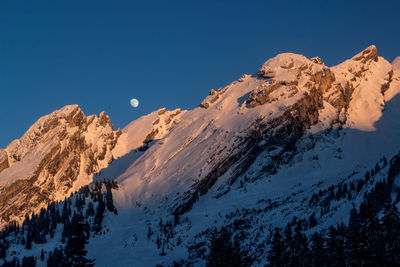 Scenic view of snowcapped mountains against clear sky