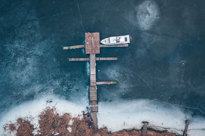 High angle view of cross sign on snow covered land