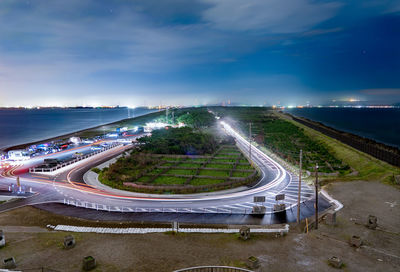 High angle view of highway by sea against sky