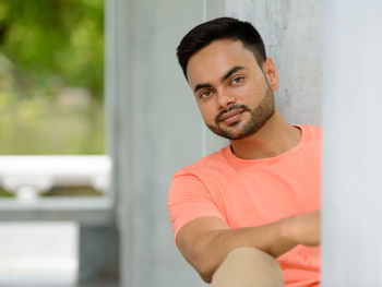 Portrait of young man sitting outdoors