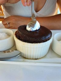 Midsection of person preparing cake