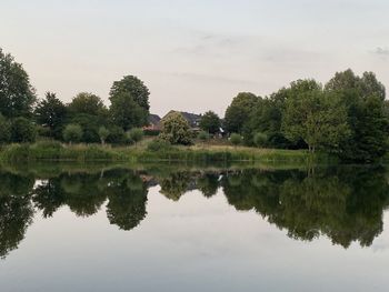 Reflection of trees in lake against sky