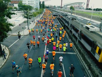 Crowd running on city street during marathon