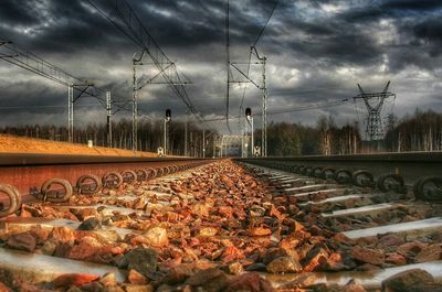 Railroad track against cloudy sky