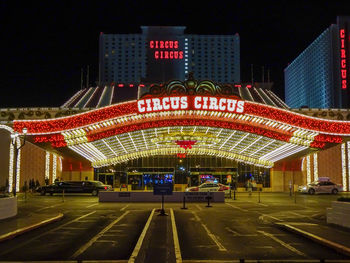 View of ferris wheel in city at night