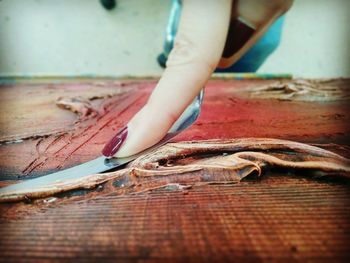 Low section of man holding wood