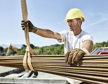 Construction worker with construction steel on construction site