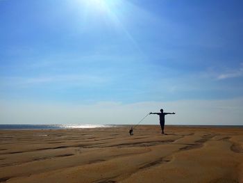 Man standing on beach against sky