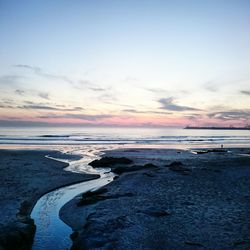 Scenic view of sea against sky at sunset