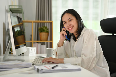 Businesswoman working at desk in office
