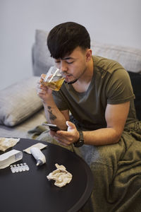 Man on sofa using cell phone