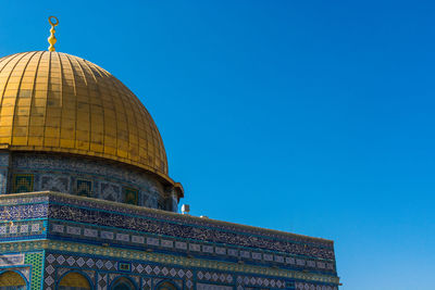 Low angle view of a building against blue sky