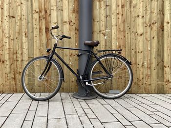 Bicycle parked on footpath by street