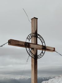 Low angle view of wooden cross against sky