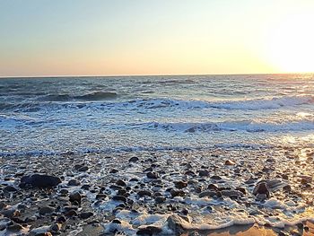 Scenic view of sea against clear sky during sunset